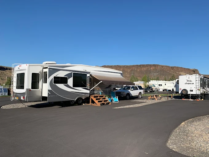RV park at dusk with canyon wall glowing orange behind the sites