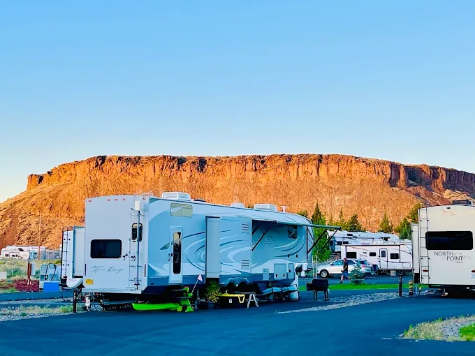 Canyon wall glowing orange at dusk behind RV sites at Copper Ridge RV Resort